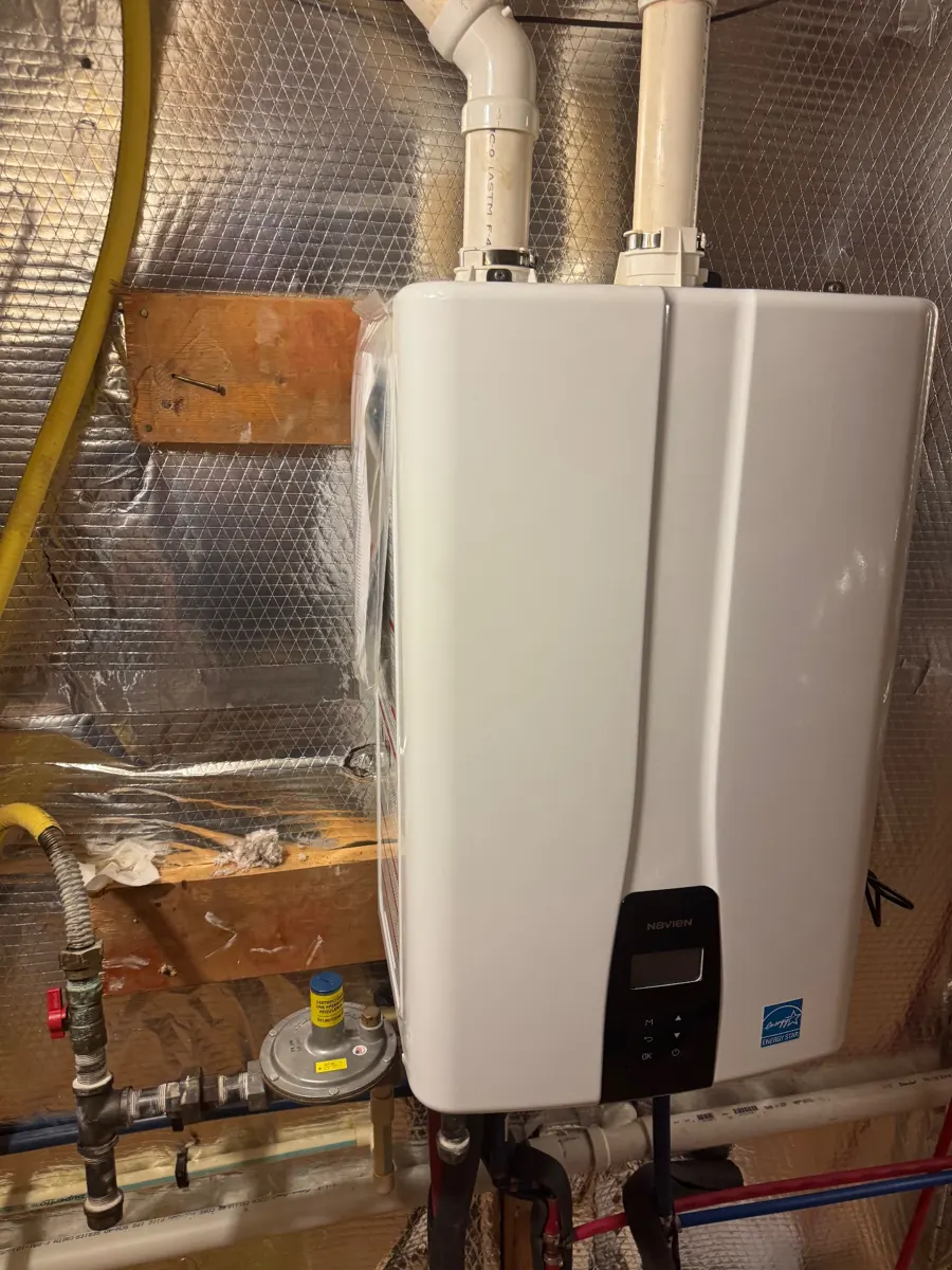 Wall-hung tankless water heater installed by Three Sons Plumbing, with its gas line and venting